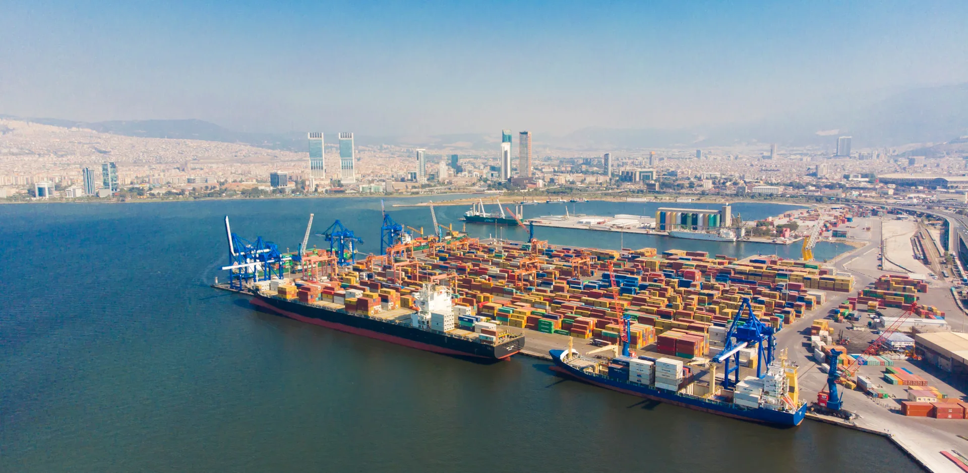 a big port with a lot of conatiners and cranes